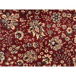 Royal Kashmir worsted wool modern Persian design area rug, with crimson field and stylised rosette patterning throughout, surrounded by wide multi-band border incorporating cartouche and lotus flower motifs