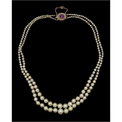  Two row graduating pearl necklace, with 9ct gold amethyst and split seed pearl clasp, retailed by Carmichael Ltd, Hull, in original leather and velvet lined box  