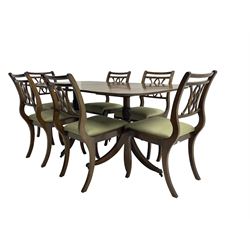 Regency design mahogany twin pedestal dining table, rectangular top with reeded edge, acanthus carved turned column terminating in reeded tripod base with hairy paw feet and castors (W172cm D92cm H75cm) and set eight (6+2) Regency design mahogany dining chairs, pierced back with scroll design, seat upholstered in patterned laurel green fabric, raised on reeded sabre supports (W48cm H88cm)