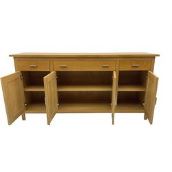 G-Plan - light oak sideboard, fitted with three drawers and four panelled cupboards