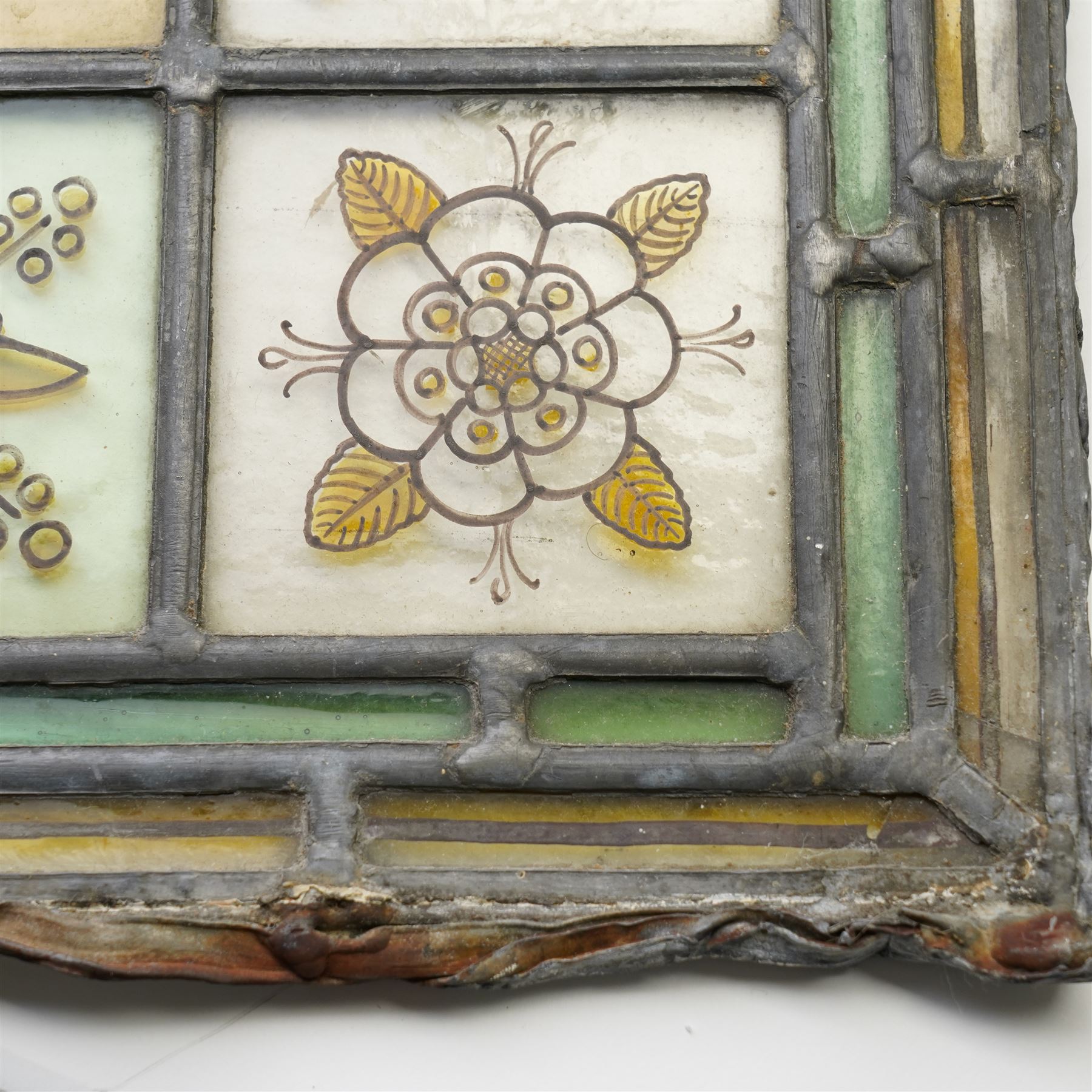 Edwardian stained glass panel, with central painted E motif surrounded by flowers and Yorkshire roses, H47cm