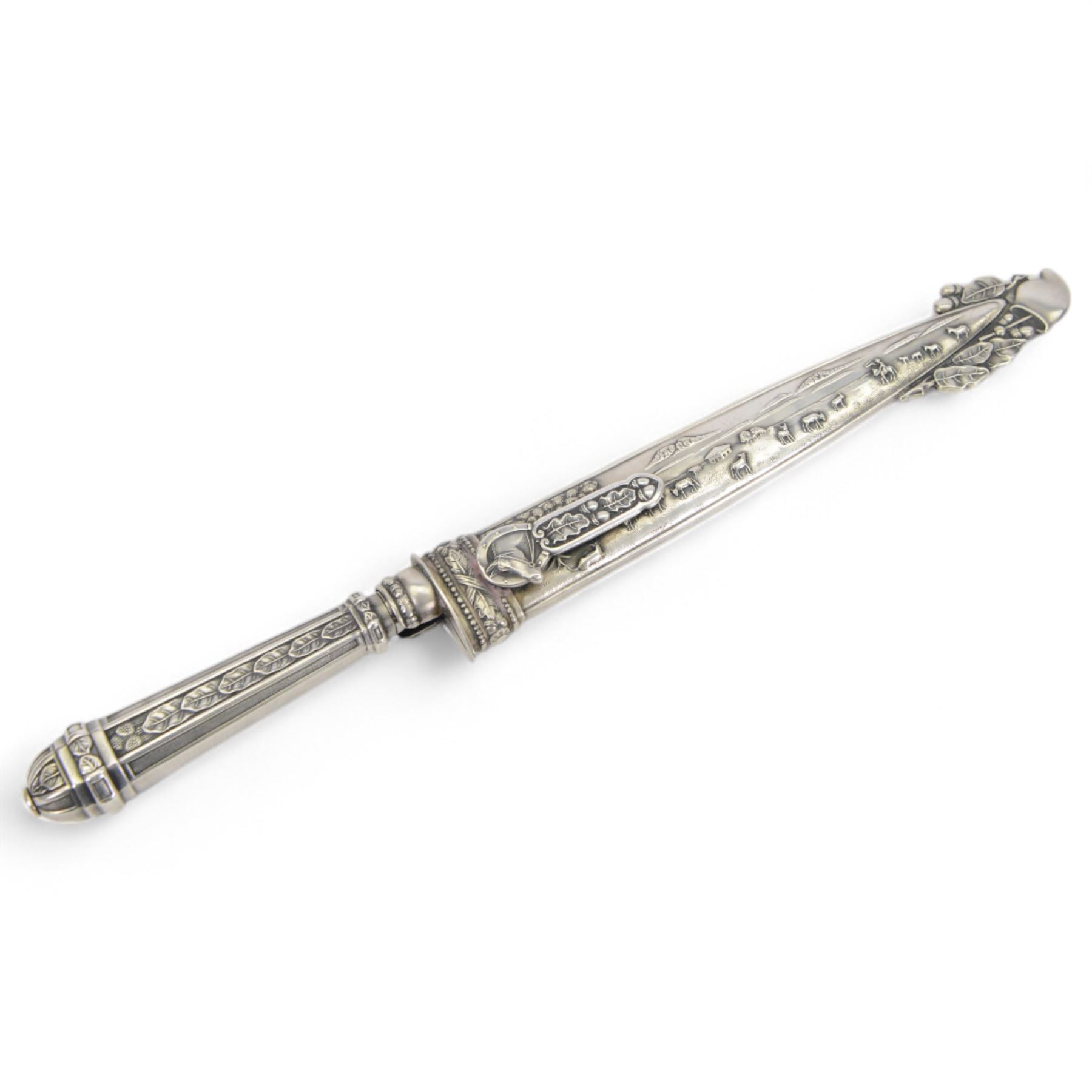 Argentinian Gaucho dagger and scabbard, decorated with oak leaves and cattle scenes with Inox blade, overall L29cm, blade 17cm