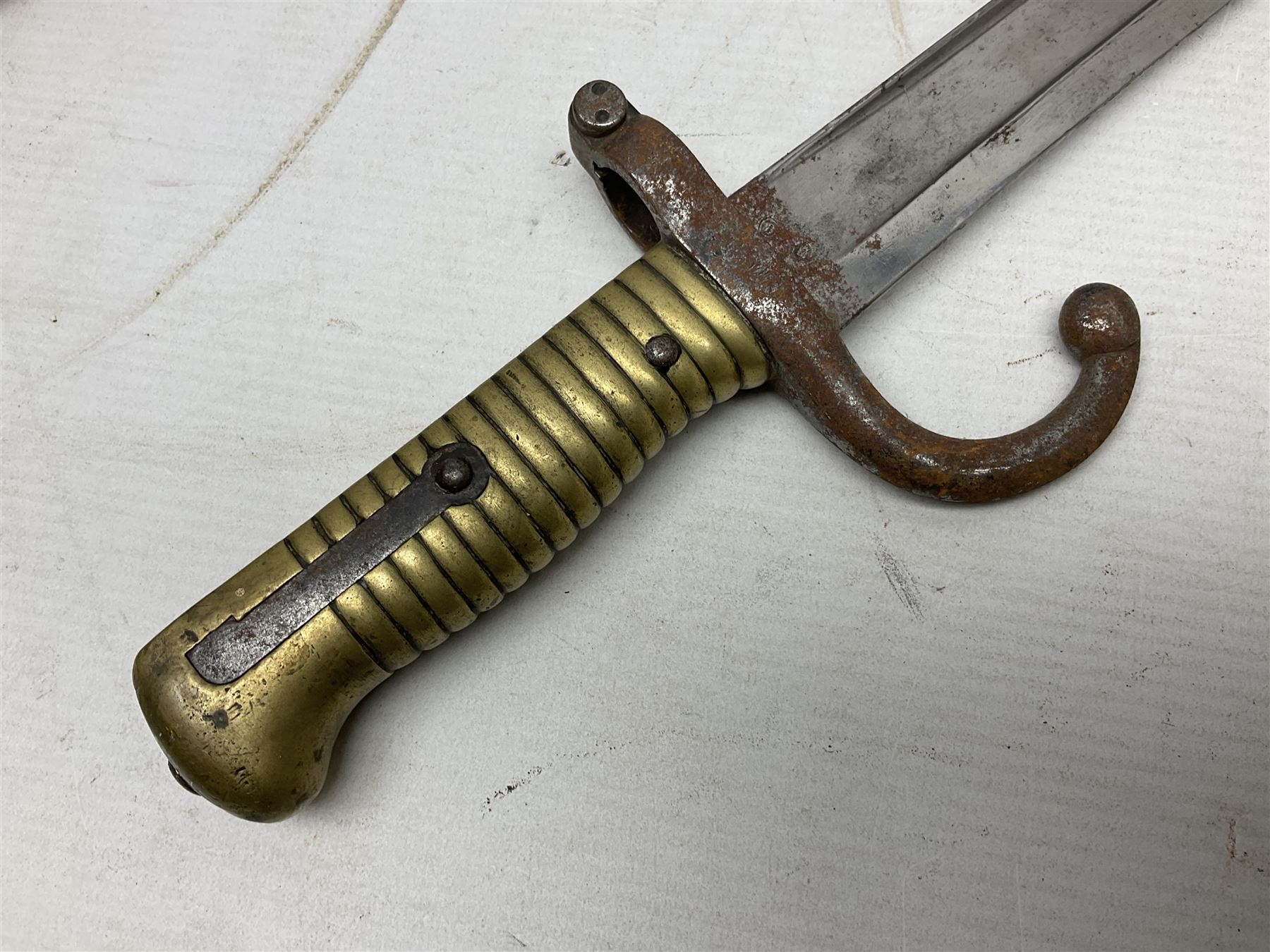 French model 1866 sabre bayonet, the 57.5cm curving blade marked St. Etienne 1873; in associated steel scabbard L71cm; and Mosin-Nagant M1891 socket bayonet with 43cm cruciform blade No.37068 (no scabbard) (2)