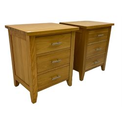 Pair of light oak three drawer bedside chests