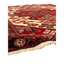 Persian Heriz wool rug, red and ivory field with floral medallion, geometric spandrels, and floral border (157cm x 107cm); Kurdish Shairwan wool rug, red and navy field with three medallions, geometric crosses and serrated border (200cm x 155cm); Persian Qashqai wool rug, golden-yellow field with boteh motifs and wide floral border (127cm x 82cm)