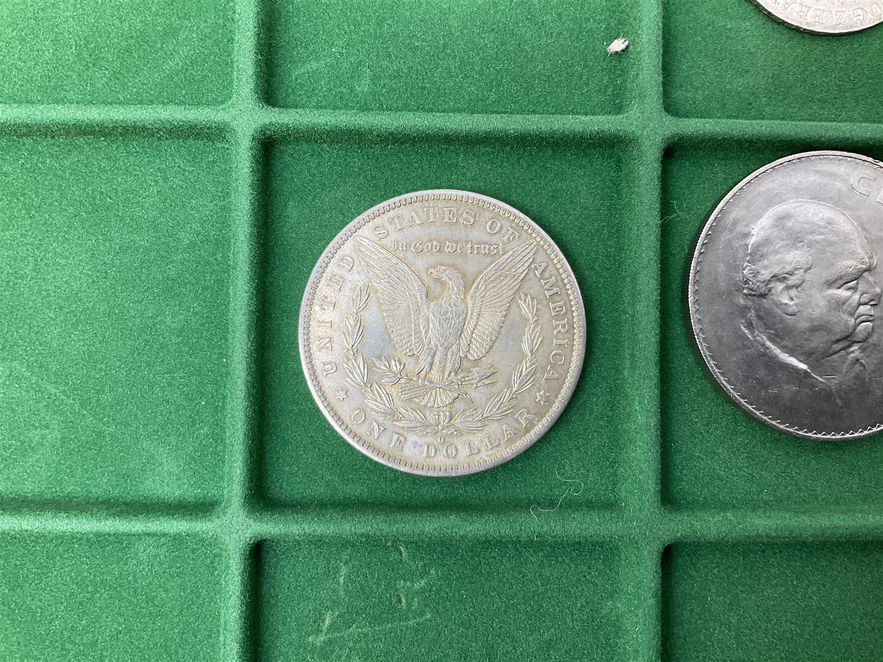 Coins and medallions including, York 1811 one shilling cattle and barber silver token, United States of America 1883O silver Morgan dollar, birds of destiny medal by Malcolm Appleby, Great British King George V 1930 halfcrown, King Edward VII 1902 silver medal, King George V 1916 halfcrown etc, housed in a case with lift out green coin trays