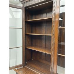 Waring and Gillow - oak bookcase on cupboard, projecting cornice over arcade frieze, guilloche upright decoration, the top section enclosed by three astragal glazed doors, the lower section enclosed by three geometric panelled doors with blind fretwork decoration, on turned feet