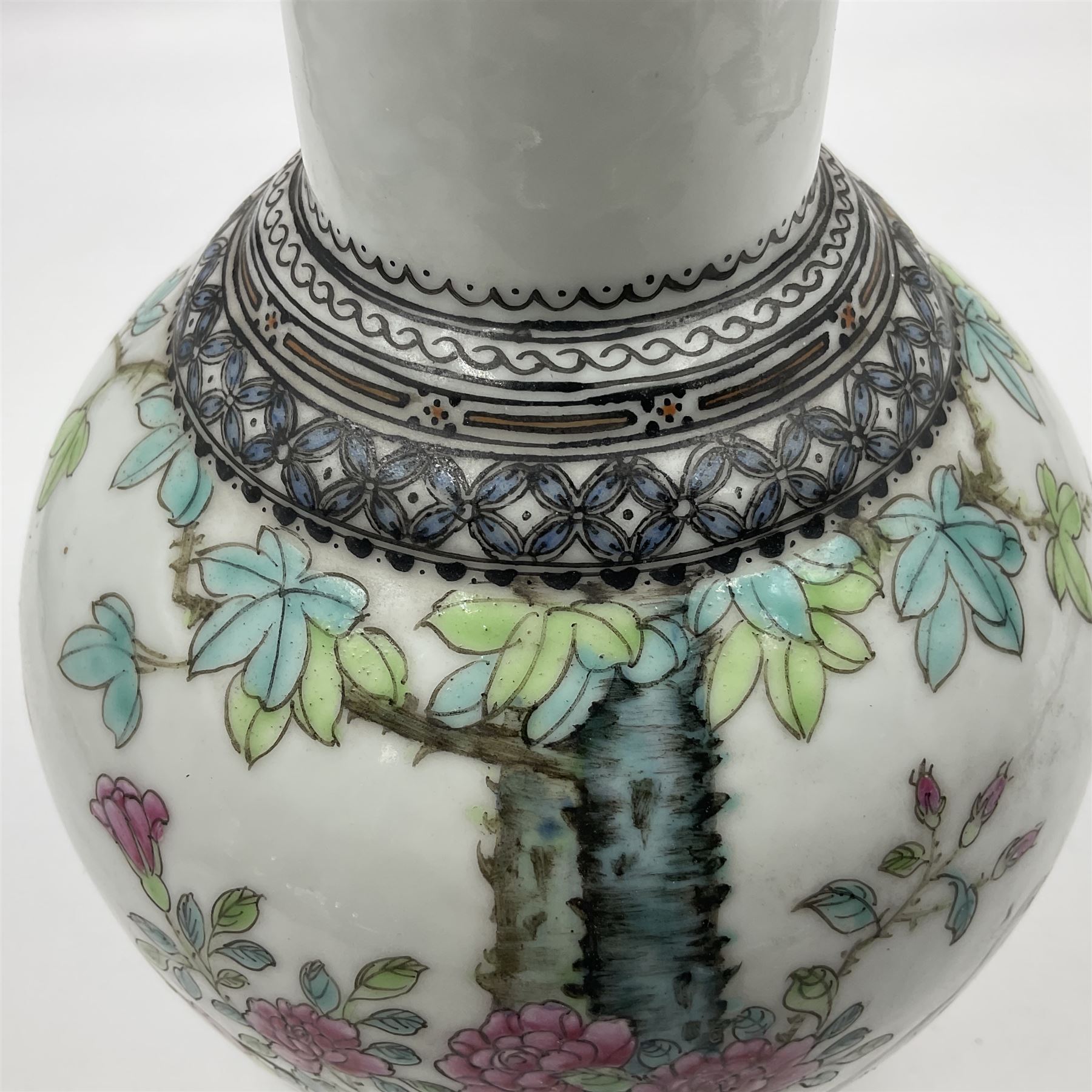 Pair of Chinese Republic porcelain vases, each painted in Famille Rose enamels with pairs of pigeons amidst peony, rock, flowering plants and leafy branches, possibly Qianlong seal beneath, H22cm 