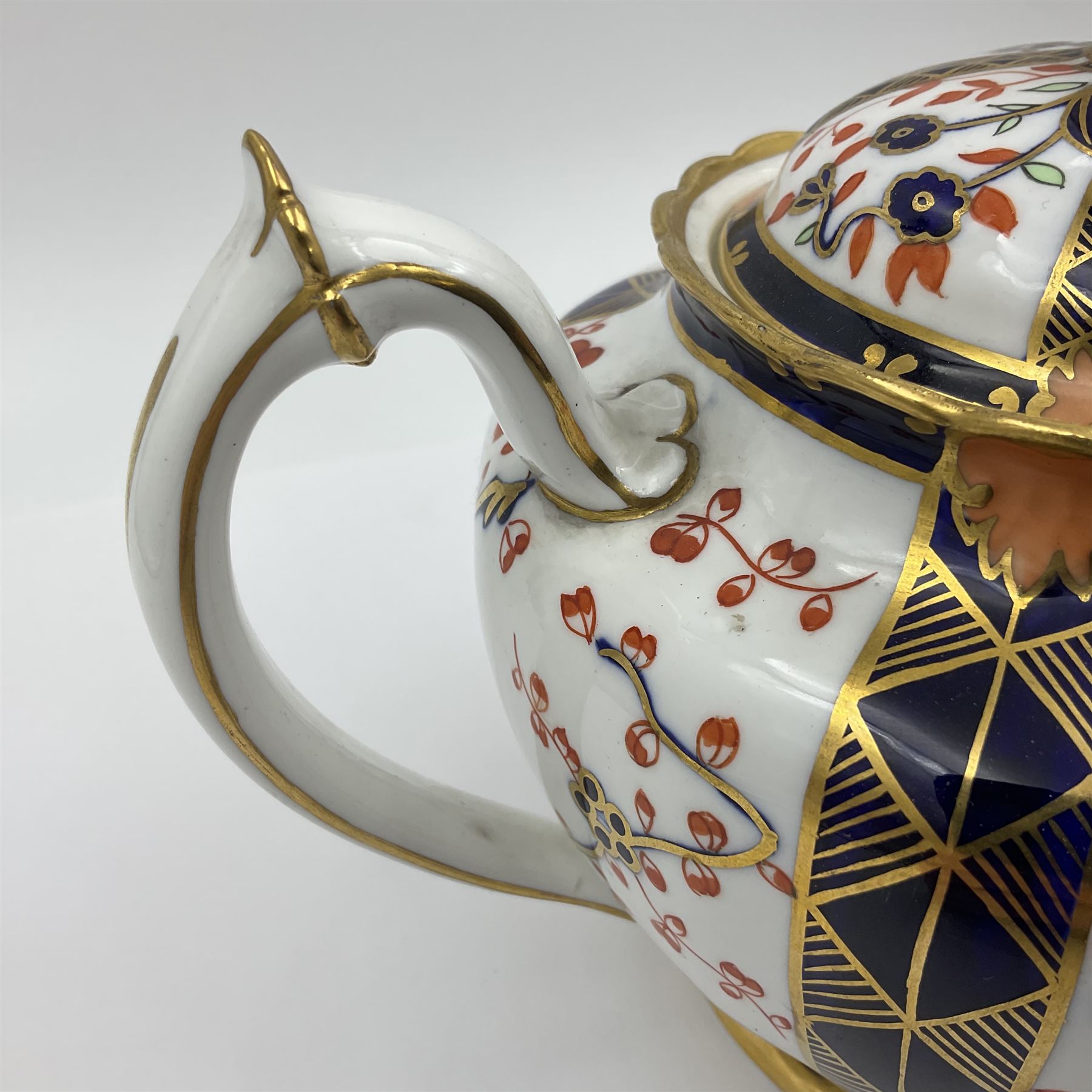 Early 20th century Royal Crown Derby teapot, decorated in a variant of the Imari pattern with blue and red prunus blossoms, with printed mark beneath including illustration date code for 1927, H14cm
