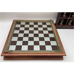 Danbury Mint 'The Fantasy of the Crystal' chess set consisting of mythical pewter chess pieces within a wooden case with chess board lid, together with 16 additional chess pieces in a wooden display case.