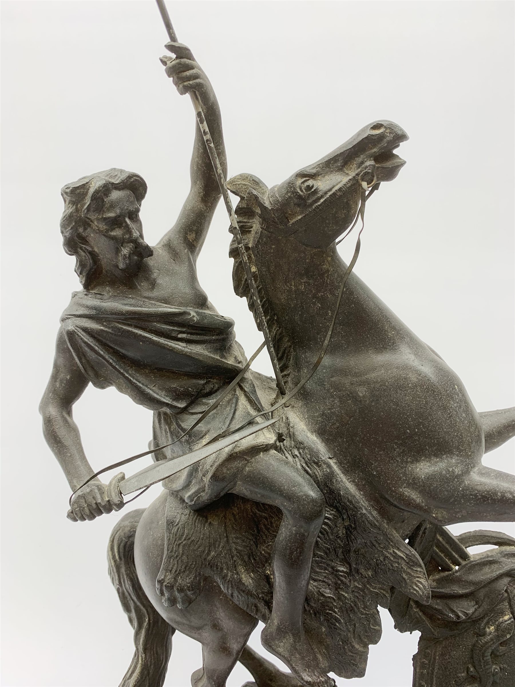 After Theodore Doriot, 19th century spelter figure of a barbarian warrior with spear and sword on a rearing horse, with battle trophies on the naturalistic base, H64cm including later ebonised wooden base
