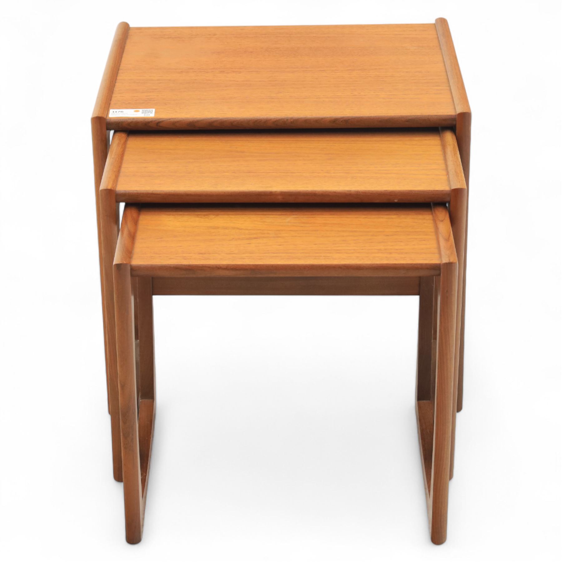 G-Plan - mid 20th century nest of three teak tables, rectangular tops with rounded edges, supported by sculptural open sided frames