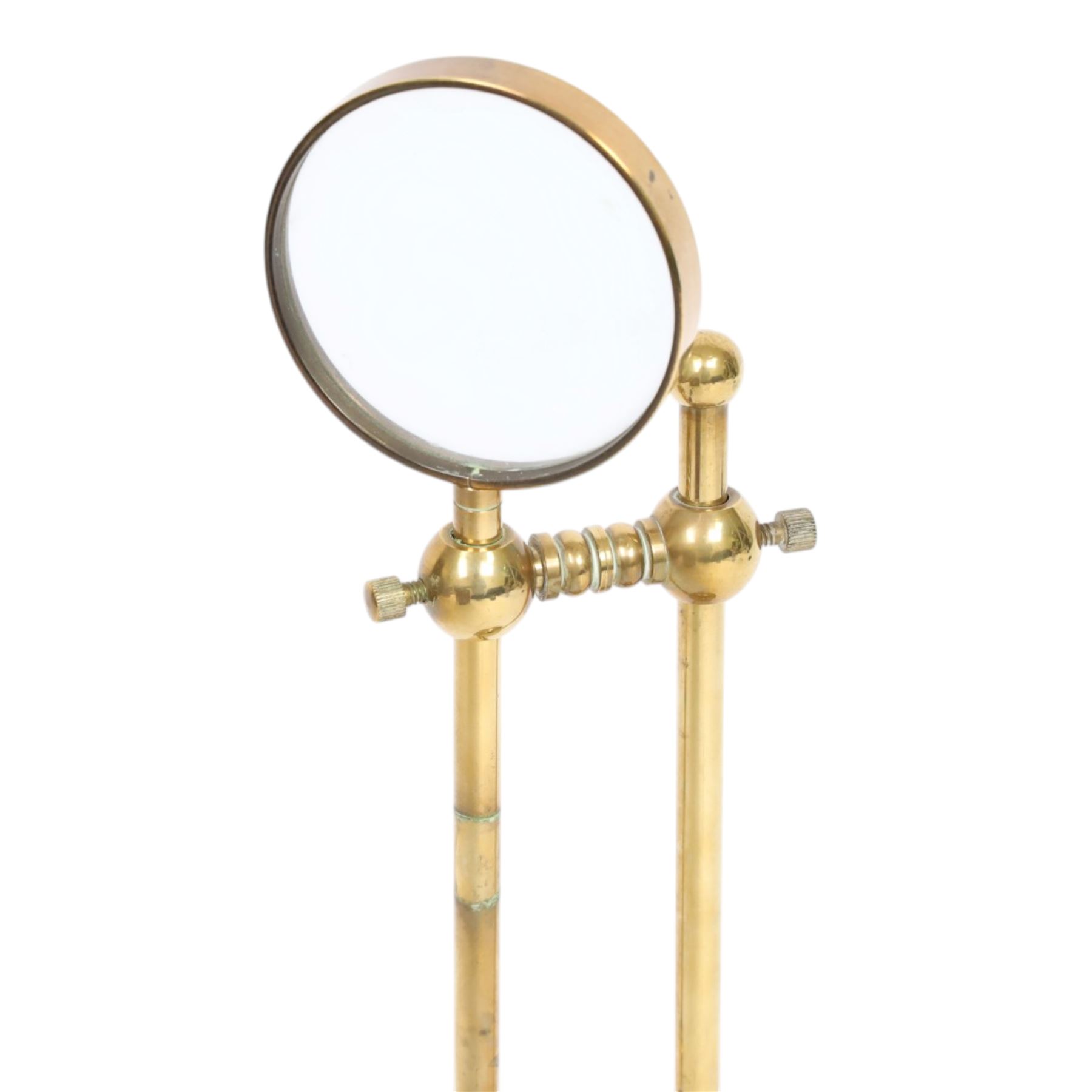 Early 20th century lacquered brass table top adjustable magnifying glass, with pivoting lens upon a circular weighted base, H26cm
