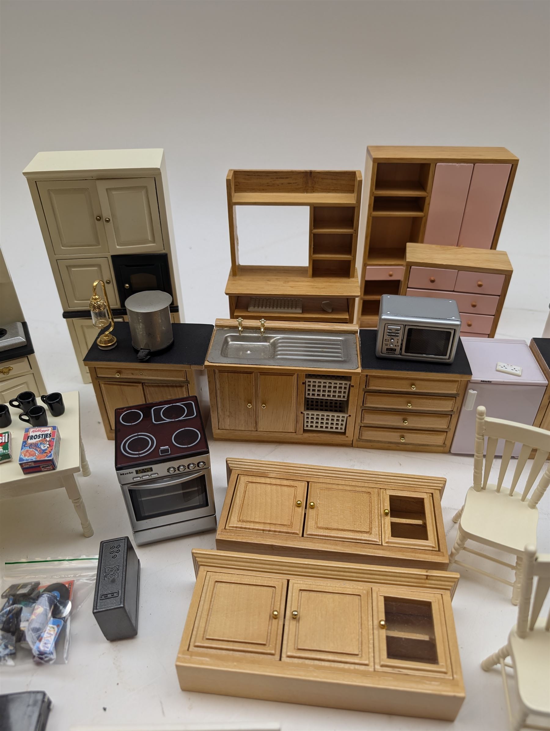 Modern 1:12 scale dolls house furniture, comprising pine kitchen set, with wall cabinets, floor cabinets and sink unit, white wooden bathroom suite, white wooden kitchen and dining room furniture and appliances, wooden bedroom furniture, Raine purple wingback chair, tv, desk, fish tank, etc