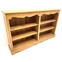 Solid pine low open bookcase, six shelves, platform base