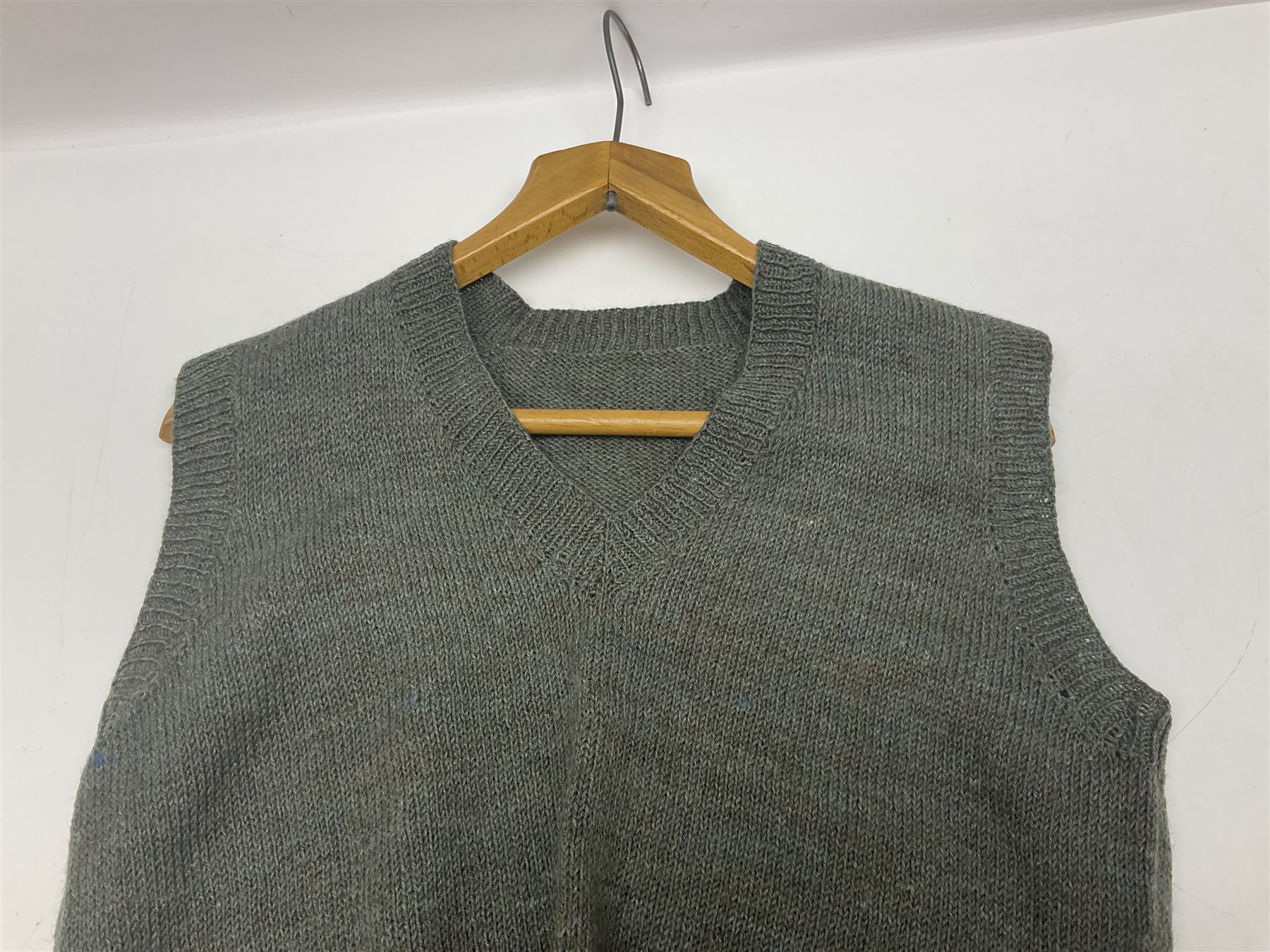 WW2 British female ATS Sergeant's service uniform grouping, consisting of four pocket female pattern service dress tunic with brass ATS shoulder titles and general service buttons; cloth lined interior with the original printed size label dated 1942; the matching khaki service dress skirt; and Greatcoat with size label dated 1945; together with army knitted sleeveless V-neck jumper; WRAC tunic, skirt and overcoat; full length cream and gold thread military evening dress by Hilliers Couture; and four webbing belts