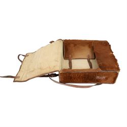 Swiss army pony skin backpack, with rolled leather edges and leather straps, the back straps stamped with Swiss cross over Sch., the fascia enclosing two belted flaps, with cream canvas lining, H38cm, W37cm