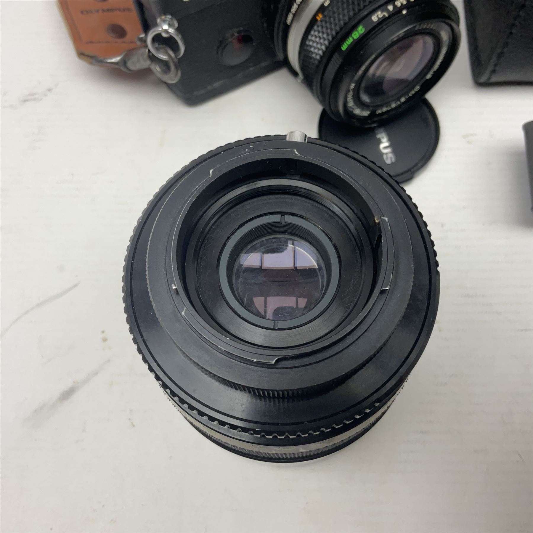 Olympus OM-2 camera body, serial no 1117526, with Olympus OM-System Zuiko Auto-W 28mm 1:2.8'  lens serial no 336591, Olympus OM10 camera body serial no 2392257, with Olympus OM-System Zuiko Auto-Macro 50mm 1:3.5' lens serial no 225784, Soligor C/D mirror lens 1:8 f=500mm' serial no 784035650 together with other camera equipment 