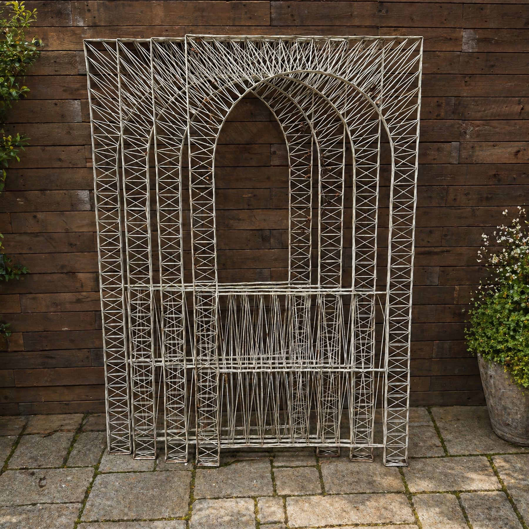 Four early 20th century French painted wicker garden trellis or dividers, rectangular form with internal arches