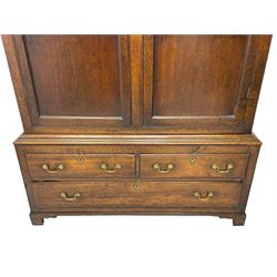 George III oak livery cupboard, projecting moulded cornice over two panelled doors, the upper panels within stepped ogee and arched moulded frame, the interior fitted with a single row of wooden hooks, two short and one long drawers, on bracket and return skirted base 