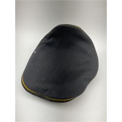 WW2 German Luftwaffe officer’s black cloth peaked cap, probably for an NCO/officer aspirant, orange piping to the crown and bordering the central band, aluminium eagle and cockade insignia, officer's bullion chin cords with pebbled buttons, interior retains original sweatband and lining has tailor's celluloid diamond with 'Erstklassig' logo