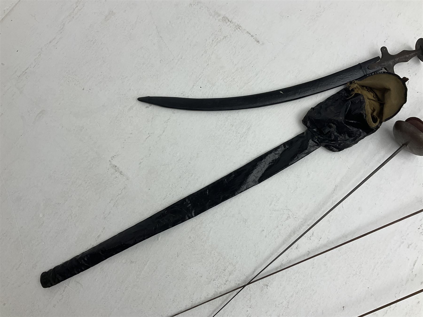 20th century Indian Tulwar sword with 71cm plain curving steel blade and iron hilt with extended langets, knopped grip and spiked pommel; in canvas covered wooden scabbard L87.5cm overall; together with five fencing swords comprising four foils and one epee, three marked Leon Paul, one in carrying case (6)