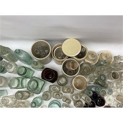 A collection of assorted glass bottles, of various size and form, mostly clear and green glass examples, plus a small group of Stoneware jars. 