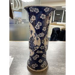 Late 19th century Chinese blue and white gu beaker vase, decorated with two lobed reserves containing precious objects, against a prunus and cracked ice ground, with apocryphal Kangxi mark beneath, H30.5cm