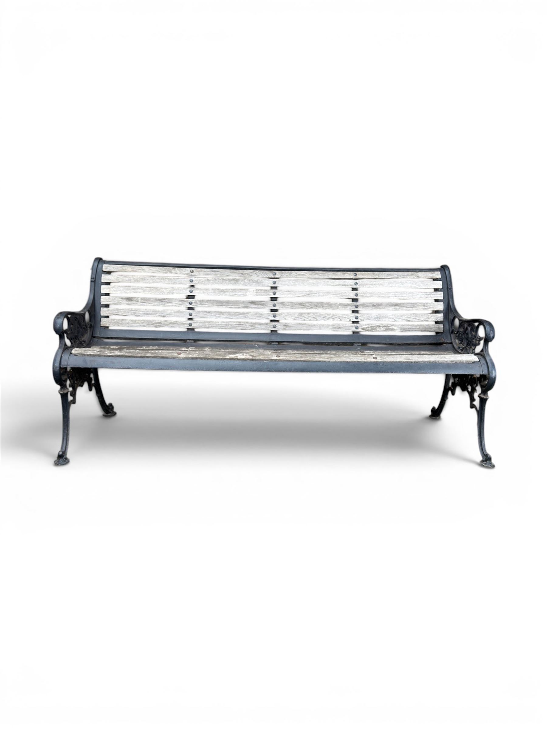 Victorian Andrew McLaren pattern cast iron bench, the ornate ends with detailed scrollwork, joined together with a cast iron seat and backrest frame supporting gently weathered oak slats, Victorian diamond stamp mark