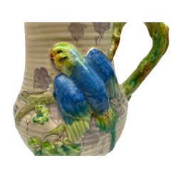 Clarice Cliff baluster jug moulded with a blue budgerigar perched upon branch with green rustic handle and mushroom glaze,  factory stamped beneath, H22.5cm