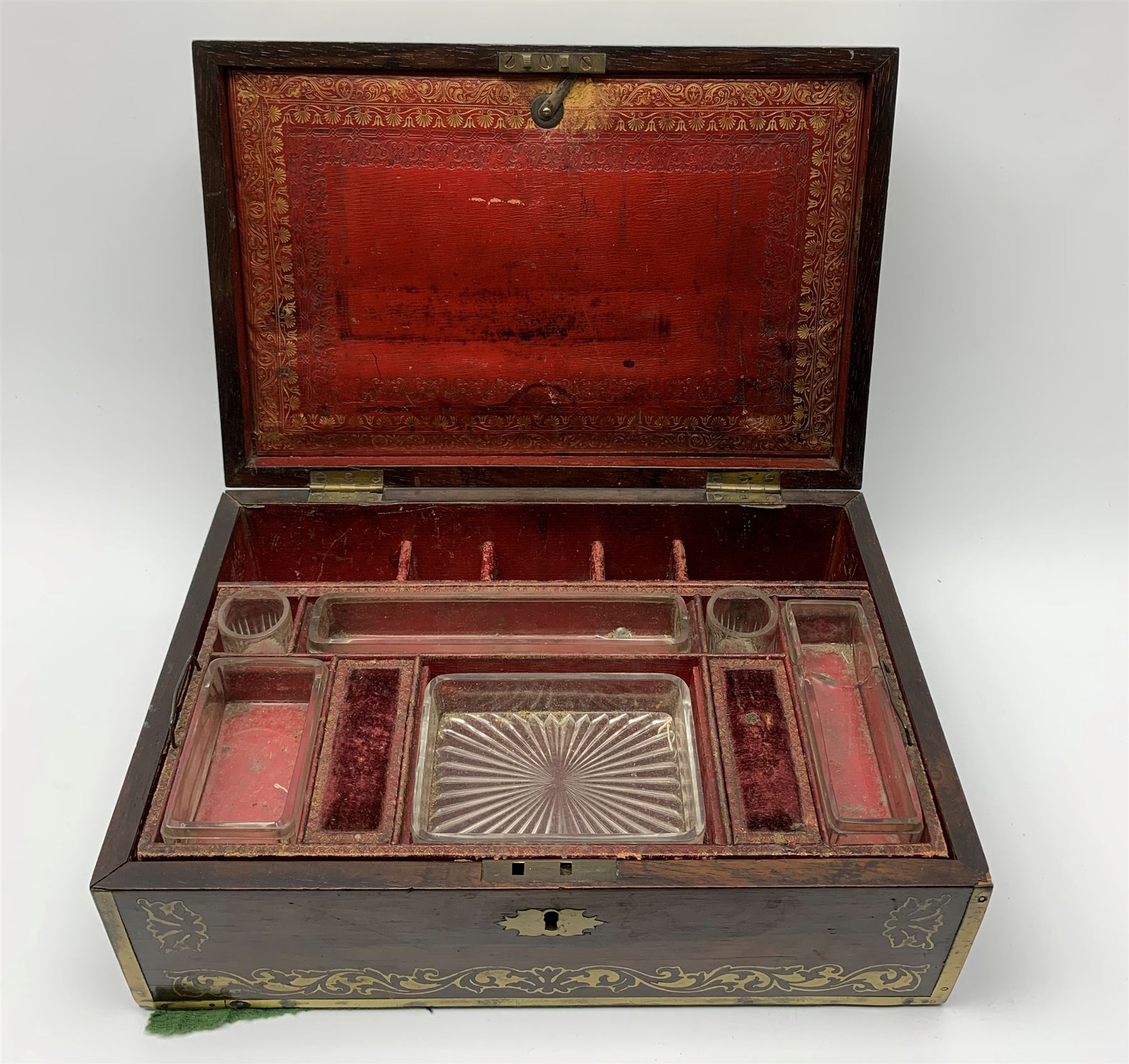 Victorian rosewood vanity box, with scrolling foliate brass inlay and twin brass inset campaign style handles, the hinged cover opening to reveal a gilt tooled interior with divisions, L33cm D22.5cm H13cm