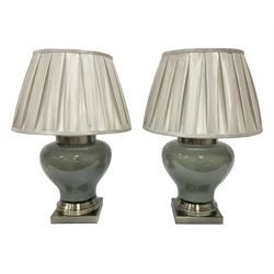 Pair of table lamps of squat baluster form, with a crackle glaze to a dark grey ground, upon a square base, including shade H57cm