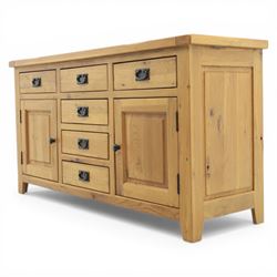Modern light oak sideboard, fitted with six drawers and two cupboards