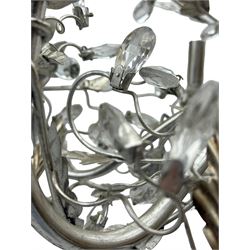 India Jane - silver finish metal chandelier, modelled with scrolling vines and leaves, embellished with faceted glass drops, fitted with six candle sconces, and wired for electricity