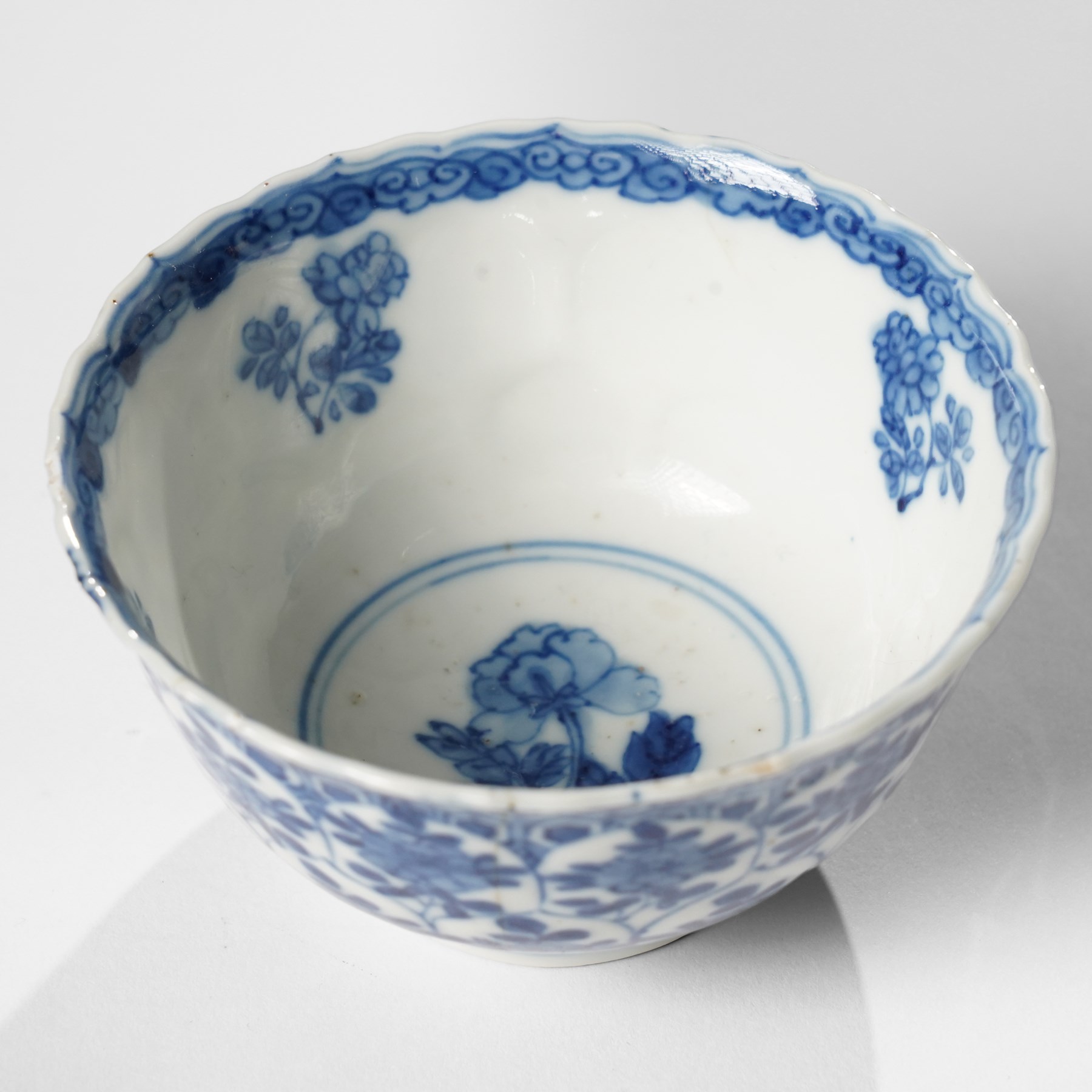 Collection of 18th century blue and white Chinese tea wares, comprising girl on swing saucer and tea bowl, boy riding buffalo tea bowl, one wine cup with foliate rim with Artemisia leaf mark to base, and similar with lotus mark to base, miniature vase, small teabowl with six character reign mark possibly Chenghua, Daoguang saucer, and others, mostly unmarked (13)