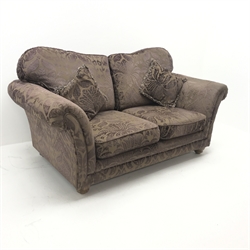 Two seat sofa upholstered in aubergine e