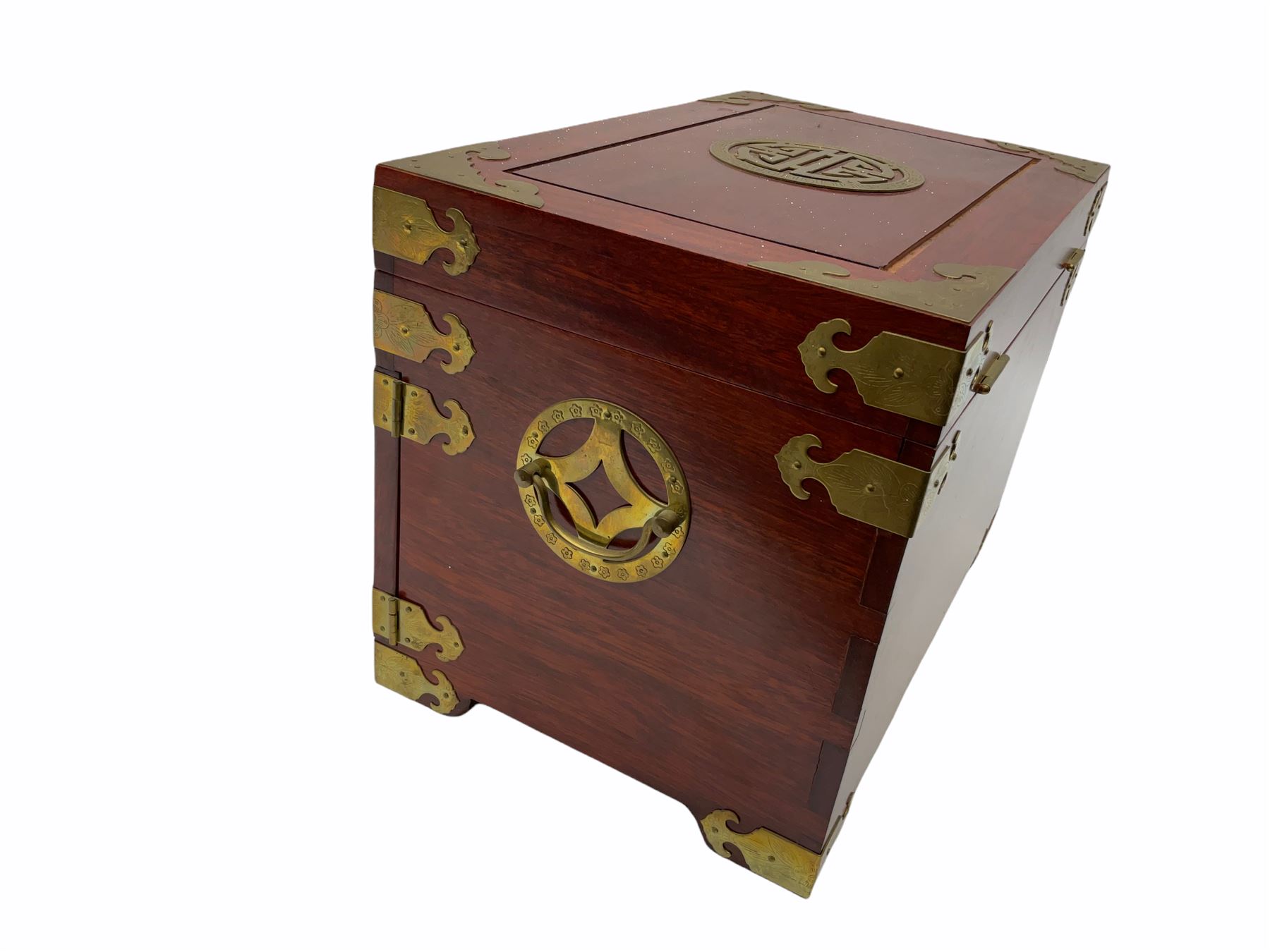 Chinese hardwood jewellery box mounted with engraved brass fixtures, the two exterior doors revealing three drawers below the hinged upper lid, lined with red material decorated with floral sprays, H25cm, W36cm, D23cm