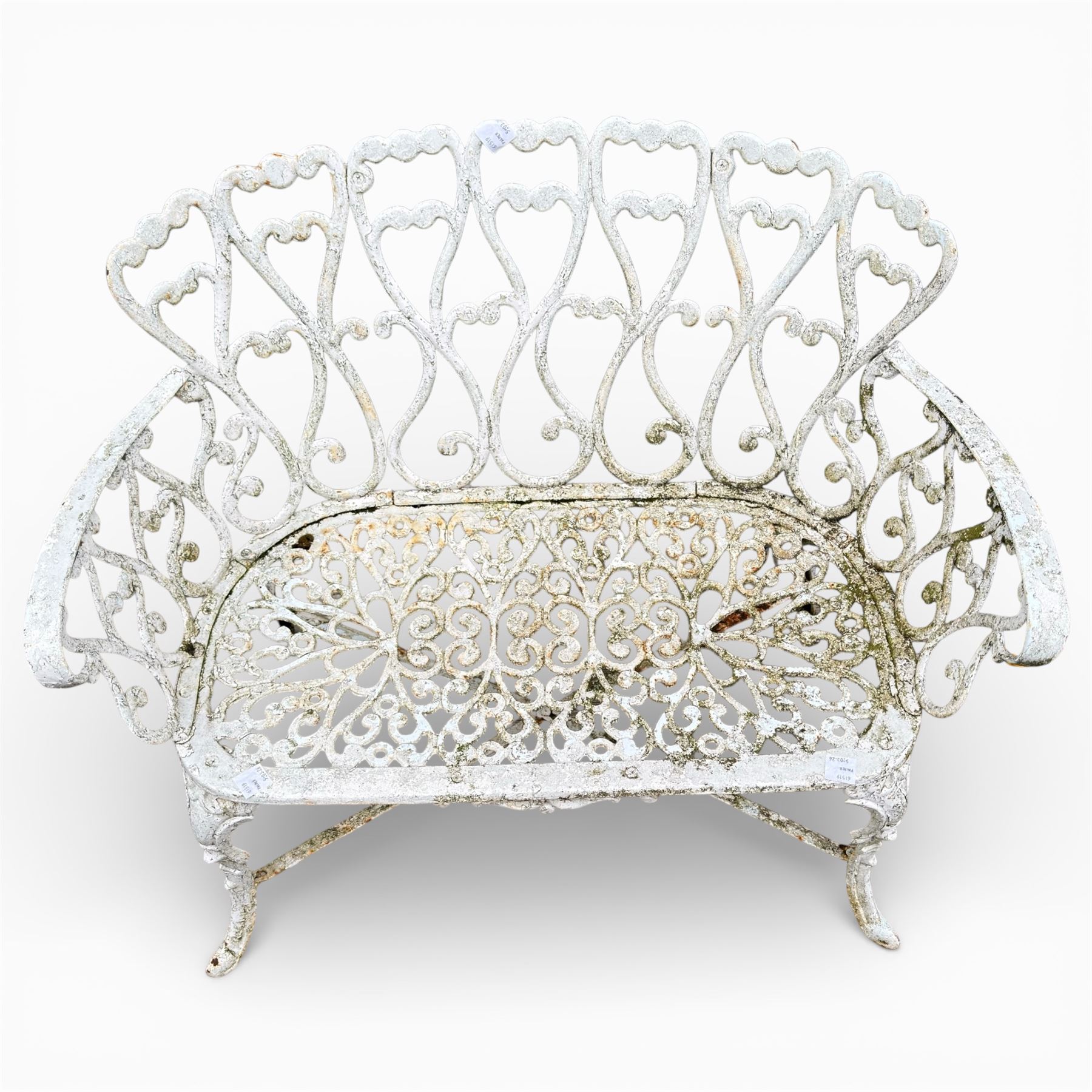 White cast metal garden bench in an antique style