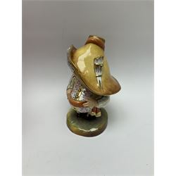 A Royal Crown Derby Mansion House dwarf, dressed in 17th century cavalier costume, with floral waistcoat and hate detailed Auction of Elegant Household Furniture and Effects, H18cm, with printed mark beneath and signed J.Aston, with makers box. 
