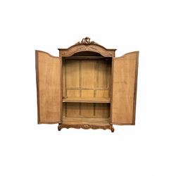 French walnut armoire wardrobe, carved feature above projecting cornice, two mirrored doors revealing shelving and hanging rail, plinth support