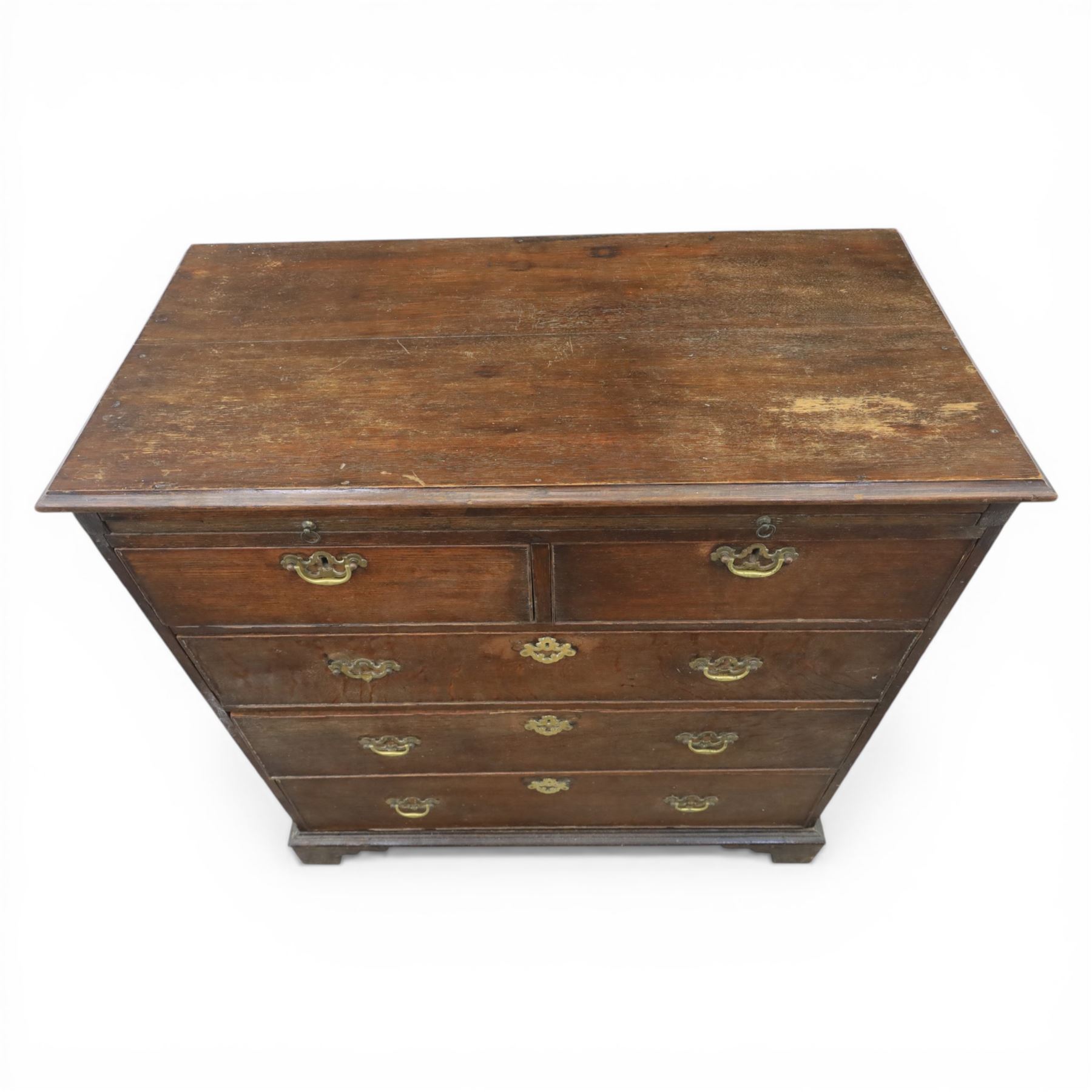 18th century oak chest, rectangular top with moulded edge, fitted with five drawers and baize line slide, with swan neck brass handles, raised on bracket feet