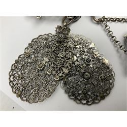 19th century continental silver plated chatelaine, the main body flanked with winged mythical beasts and central soldier slaying a dragon supporting three suspended items to include velvet lined small basket and long clasped filigree chain, together with a thimble