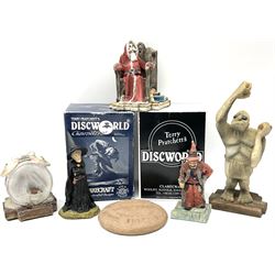 Terry Pratchett Discworld figures, designed by Clarecraft, comprising Lias Bluestone DW82, Hogfather DW72, Granny Weatherwax, boxed, DW06, Ridcully DW61and 'Ironcrust's genuine dwarf bread'.