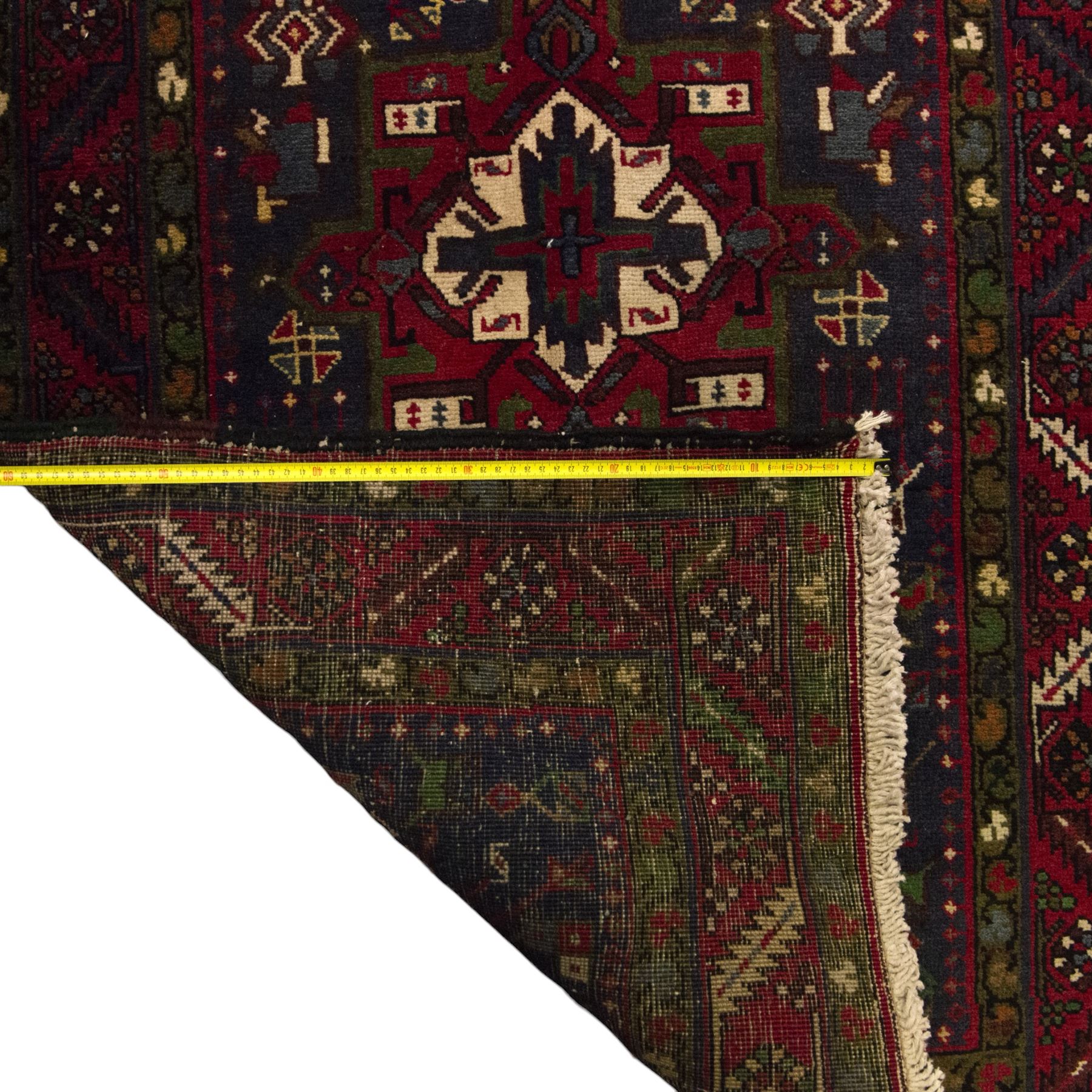 Large Northwestern Persian Hamadan hand-knotted runner, indigo field, with a column of bold geometric medallions and scattered stylized motifs within a madder border of angular rosettes and meandering vines 