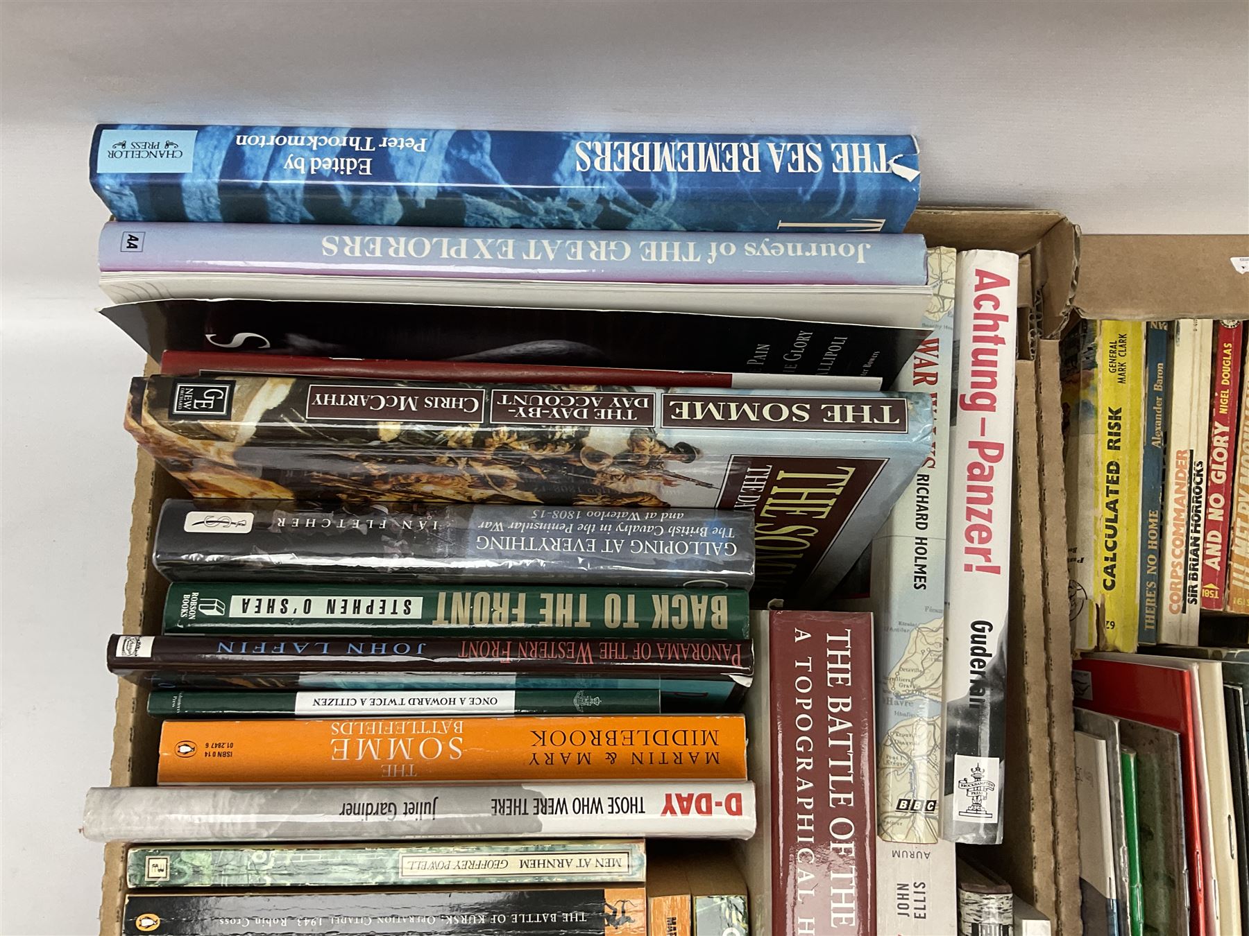 Large collection of hardback and paperback books, mainly military books, to include Band of Brothers, Dawn of D-Day, Dessert Warrior, Book of the Somme, Battle of Britain, etc in four boxes  