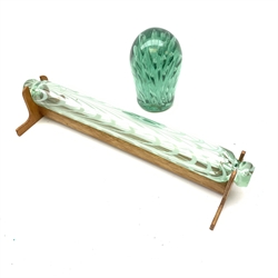 A 19th century Nailsea style glass rolling pin, with wooden display stand, L40cm, together with a Victorian green glass dump paperweight with internal captive bubble decoration, H15cm. 
