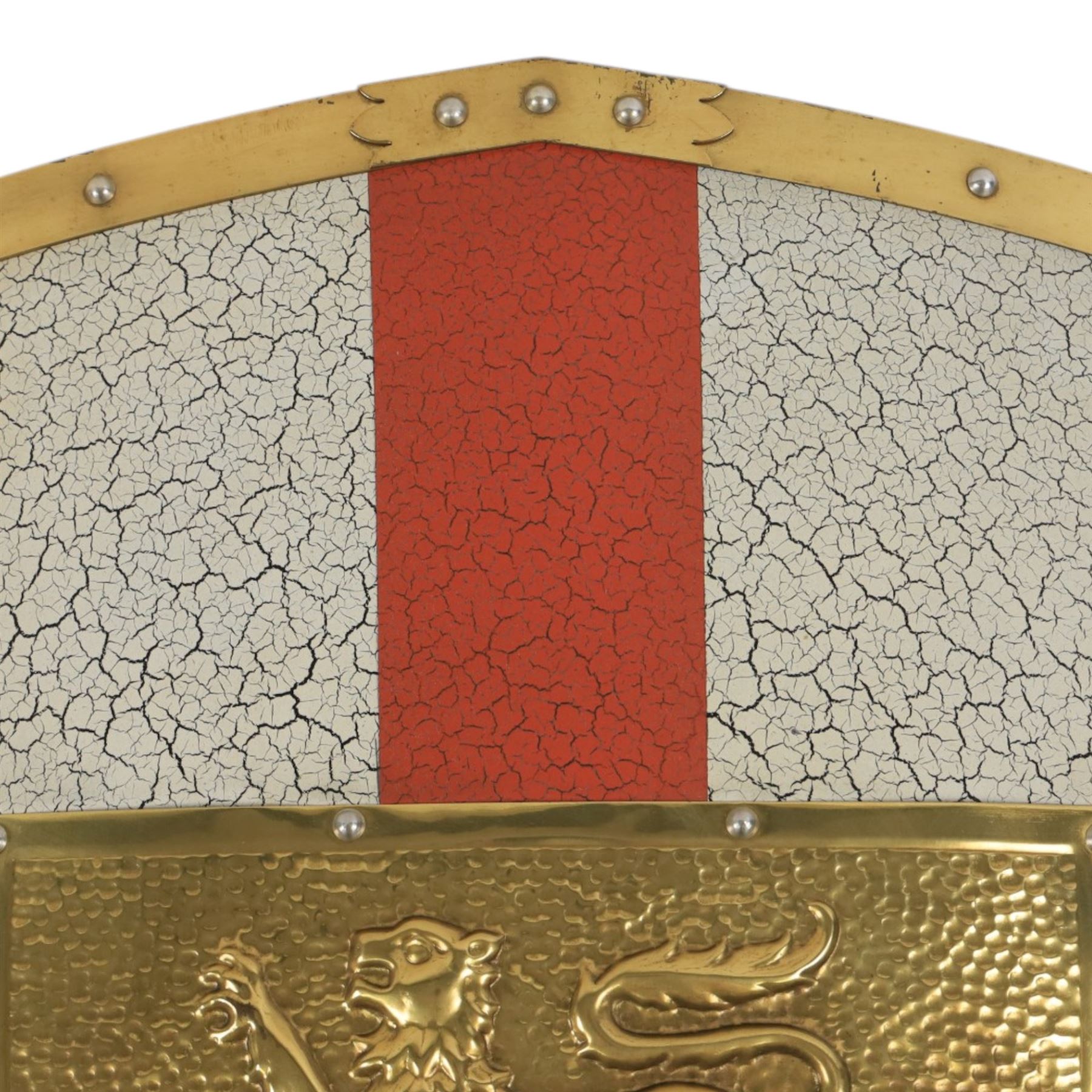 Five wall hangings, modelled as shields, decorated to the centre in relief with three lions 