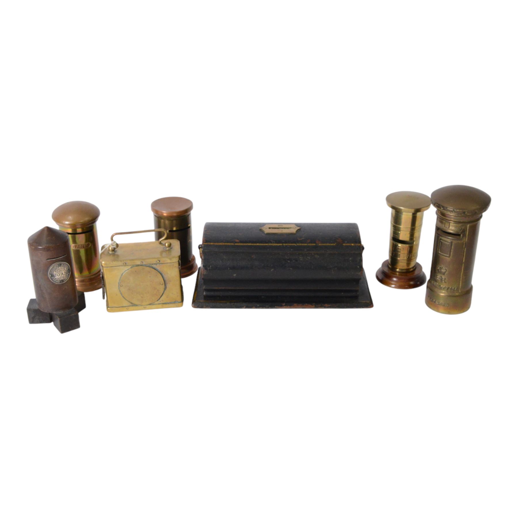 Early 20th century moneyboxes, including trench art example, Bakelite example with applied West Africa Two Shilling coin engraved 'Joan', three brass pot boxes and a wooden ebonised example with brass mounts, tallest H15cm
