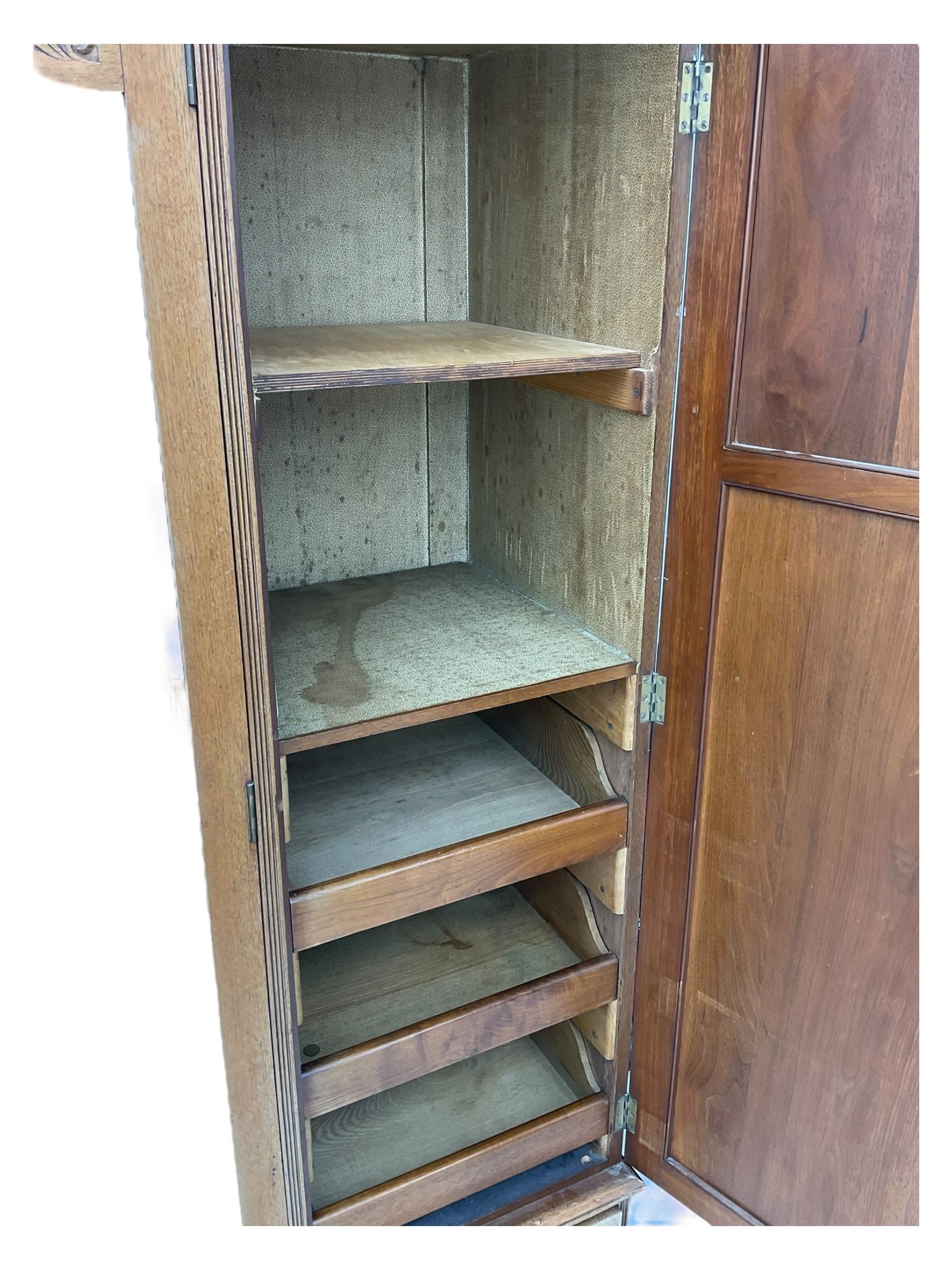 Late Victorian walnut triple combination wardrobe, projecting moulded and dentil cornice, central shaped bevelled mirror glazed door, cartouche and curled leaf carved panels over figured walnut veneered panels, fitted with drawer to base, on bracket feet