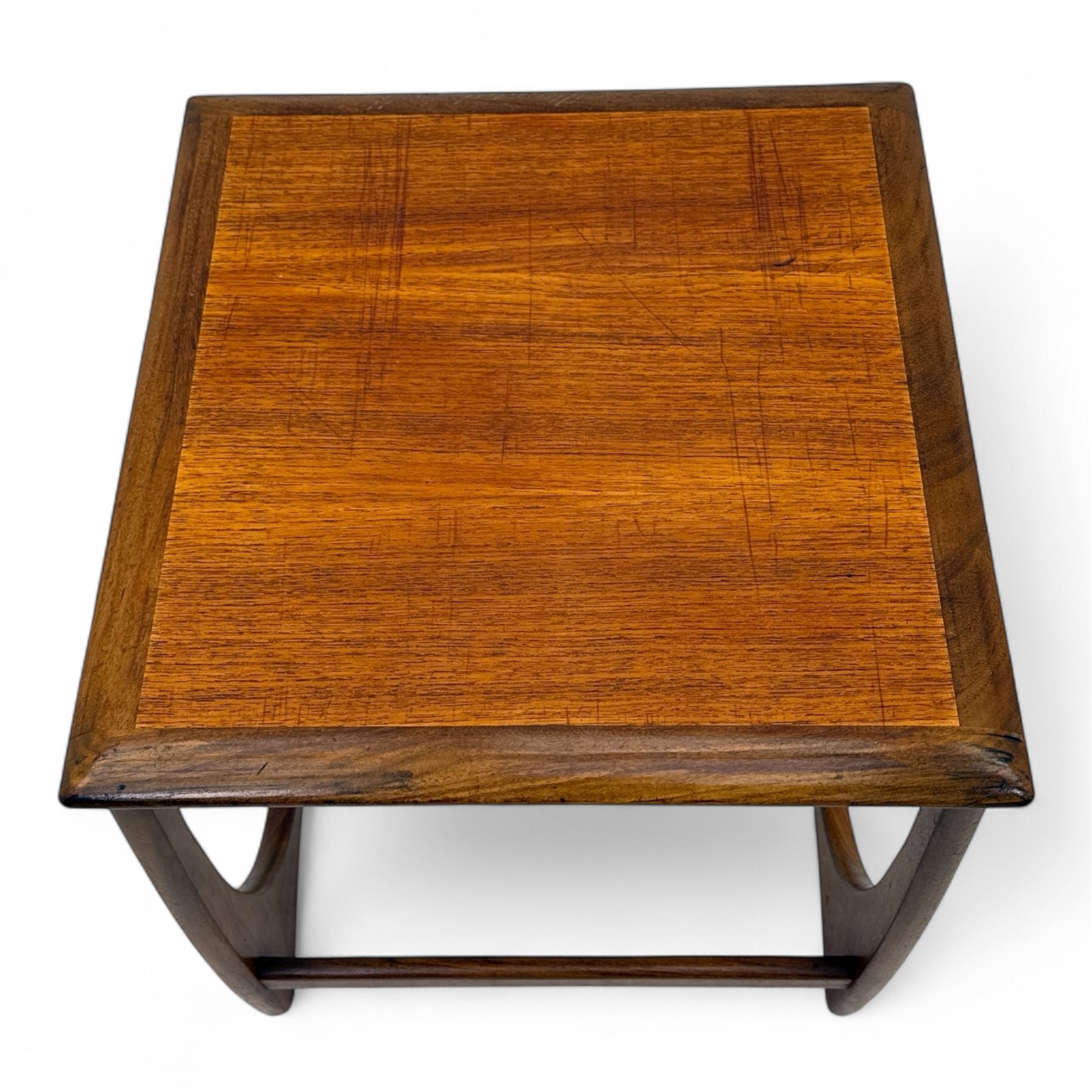 G-Plan - 'Astro' mid mid-century long teak coffee table with two nesting tables, rectangular top with outer banding, above two square top occasional tables on U-shaped end supports united by a stretcher